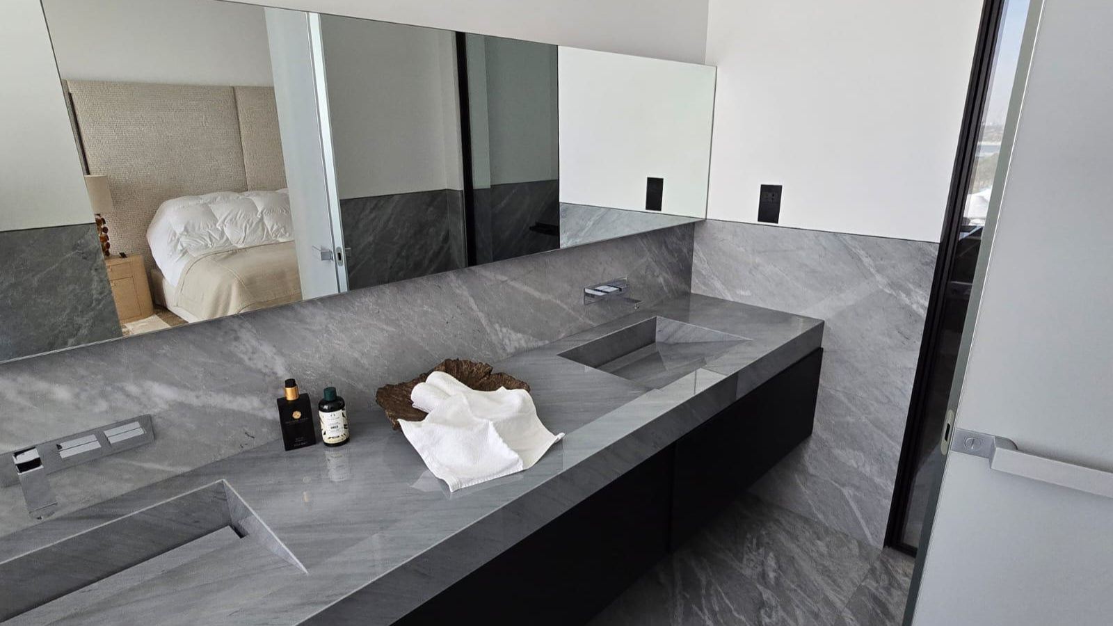 Modern bathroom with a large mirror and gray countertop